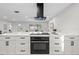 Bright open kitchen featuring white cabinets, quartz countertops, and stainless steel appliances at 105 12Th Sw St, Ruskin, FL 33570