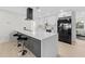 Kitchen showcasing the island with barstool seating, quartz countertops, and stainless steel appliances at 105 12Th Sw St, Ruskin, FL 33570