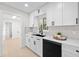 Modern kitchen sink with white cabinets, quartz countertops, and stainless steel appliances at 105 12Th Sw St, Ruskin, FL 33570