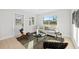 Bright living room with modern decor, stylish seating, and natural light from large windows at 105 12Th Sw St, Ruskin, FL 33570