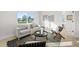 Cozy living room showcasing a comfortable sofa, minimalist decor, and bright, sunlit ambiance at 105 12Th Sw St, Ruskin, FL 33570