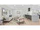 Bright living room featuring modern decor, light wood floors, and an open layout with a kitchen view at 105 12Th Sw St, Ruskin, FL 33570