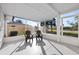 Relaxing screened-in porch with outdoor seating and views of a green lawn and trees at 105 12Th Sw St, Ruskin, FL 33570