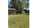 Large backyard with lush grass, palm trees, and a privacy fence, perfect for outdoor activities at 1317 W Alicia Ave, Tampa, FL 33604