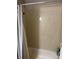 Bathroom with tiled shower and bathtub; shower curtain included at 1317 W Alicia Ave, Tampa, FL 33604