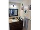 Cozy bathroom features a granite-topped vanity, decorative wall art, and modern fixtures at 1317 W Alicia Ave, Tampa, FL 33604