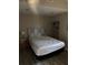 Bedroom with built-in shelving, wood laminate floors, and a patterned headboard at 1317 W Alicia Ave, Tampa, FL 33604