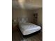Bedroom with built-in shelving, wood laminate floors, and a patterned headboard at 1317 W Alicia Ave, Tampa, FL 33604