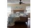 Bedroom with a ceiling fan, beach themed decorations, and side tables with lamps at 1317 W Alicia Ave, Tampa, FL 33604