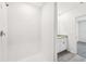 Modern bathroom featuring a walk-in shower with white tiling and a granite vanity at 14005 Crutchfield Ct, Parrish, FL 34219