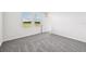 Bedroom features neutral carpet and two windows for natural light at 14005 Crutchfield Ct, Parrish, FL 34219