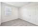 Comfortable bedroom with neutral carpet, white walls, a window, and closet door at 14005 Crutchfield Ct, Parrish, FL 34219