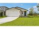 Charming single-story home with a two-car garage, well-manicured lawn, and inviting front door at 14005 Crutchfield Ct, Parrish, FL 34219
