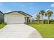 Inviting single-story home featuring a two-car garage, large driveway, and lovely landscaping at 14005 Crutchfield Ct, Parrish, FL 34219