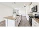 Modern kitchen featuring granite countertops, an island with a sink, and stainless steel appliances at 14005 Crutchfield Ct, Parrish, FL 34219