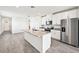 Modern kitchen with stainless steel appliances, granite countertops, and a large kitchen island at 14005 Crutchfield Ct, Parrish, FL 34219
