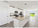 Bright kitchen featuring stainless steel appliances, granite counters, and an open layout with access to the outdoors at 14005 Crutchfield Ct, Parrish, FL 34219