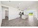 Open-concept living space with tile flooring and access to the kitchen and outdoor area at 14005 Crutchfield Ct, Parrish, FL 34219