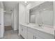 Elegant bathroom featuring double sinks, quartz countertops, and a framed mirror at 14076 Crutchfield Ct, Parrish, FL 34219