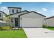 Charming single-Gathering home featuring a two-car garage, manicured lawn, and a welcoming entrance at 14076 Crutchfield Ct, Parrish, FL 34219