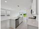 Modern kitchen boasts stainless steel appliances, quartz countertops, and an island with a sink at 14076 Crutchfield Ct, Parrish, FL 34219