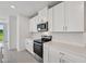 The kitchen is equipped with stainless steel appliances, and bright white cabinets at 14076 Crutchfield Ct, Parrish, FL 34219