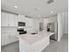 Modern kitchen featuring white cabinets, stainless steel appliances, and a spacious center island at 14076 Crutchfield Ct, Parrish, FL 34219