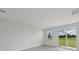 Bright living room featuring a window and sliding glass door to the back yard at 14076 Crutchfield Ct, Parrish, FL 34219