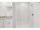 Modern bathroom featuring tiled shower with glass door and granite countertop vanity at 14115 Crutchfield Ct, Parrish, FL 34219