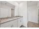 Bathroom with double vanity, granite countertop, and walk-in shower with neutral tile at 14115 Crutchfield Ct, Parrish, FL 34219
