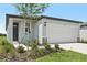 Charming single-Gathering home featuring a two-car garage, landscaped yard, and a covered entry at 14115 Crutchfield Ct, Parrish, FL 34219