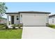 Charming single-story home featuring a two-car garage, well-maintained lawn, and inviting front entrance at 14115 Crutchfield Ct, Parrish, FL 34219