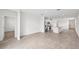Open floor plan with tile floors connecting the living area, dining space, and modern kitchen at 14115 Crutchfield Ct, Parrish, FL 34219