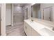 Modern bathroom with double sinks, white cabinets, and a tiled walk-in shower at 2277 Broadpoint Dr, Punta Gorda, FL 33983
