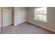 This carpeted bedroom features a window with natural light and a closet for storage at 2277 Broadpoint Dr, Punta Gorda, FL 33983