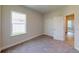 This carpeted bedroom is filled with natural light from a window and has a closet for storage at 2277 Broadpoint Dr, Punta Gorda, FL 33983