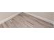 Close-up of light wood-look tile flooring with white baseboards at 2277 Broadpoint Dr, Punta Gorda, FL 33983