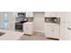 Modern kitchen with white cabinetry, stainless steel appliances, and a stylish backsplash at 2277 Broadpoint Dr, Punta Gorda, FL 33983