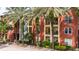 A view of the exterior showing multi-story building with balconies and mature palm trees at 2411 W Horatio St # 537, Tampa, FL 33609