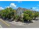 Multi-story condo exterior with mature trees and landscaped grounds, located on a corner lot at 2411 W Horatio St # 537, Tampa, FL 33609
