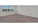 A bright bedroom features shuttered windows and neutral carpeting at 32740 Tree Of Life Ave, Wesley Chapel, FL 33543