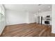 A view of the living room featuring hardwood floors with stainless steel appliances in the background at 4249 Banjo Lake Rd, Land O Lakes, FL 34639