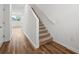 This staircase has neutral carpet, wood-look floors, and white walls for a clean aesthetic at 4249 Banjo Lake Rd, Land O Lakes, FL 34639