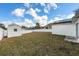 Expansive backyard enclosed by a white fence, enhanced by a storage shed and solar panels at 4604 Hunts Ave, Plant City, FL 33566