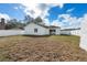 Spacious backyard with a white fence and potential for landscaping at 4604 Hunts Ave, Plant City, FL 33566
