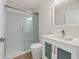 Modern bathroom features a glass enclosed shower, white cabinets and vinyl floors at 4604 Hunts Ave, Plant City, FL 33566