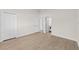 Empty bedroom features a double door closet, vinyl floors and white trim at 4604 Hunts Ave, Plant City, FL 33566
