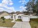 Charming single-story home with a well-maintained lawn, attached garage, and inviting curb appeal under a partly cloudy sky at 4604 Hunts Ave, Plant City, FL 33566