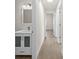 Bright hallway featuring wood-look floors and white walls leading to rooms at 4604 Hunts Ave, Plant City, FL 33566
