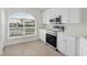 Stylish kitchen boasts stainless steel appliances, white cabinets, and a large window, offering a bright and functional cooking space at 4604 Hunts Ave, Plant City, FL 33566